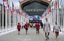 People walk in front of the canteen in the Olympic Village, at the 2024 Summer Olympics in Paris, 22 July 2024