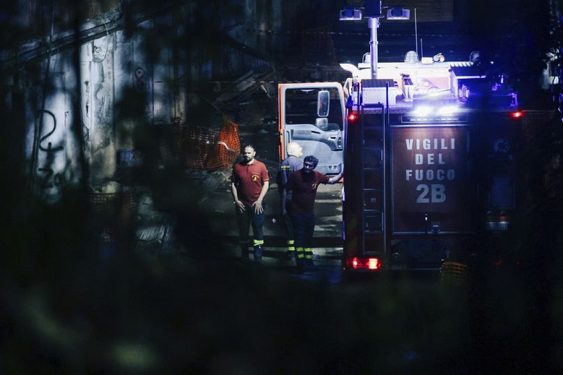 Emergency services work on a site of a pedestrian walkway collapsed, in Naples, Italy, Tuesday, July 23, 2024. 