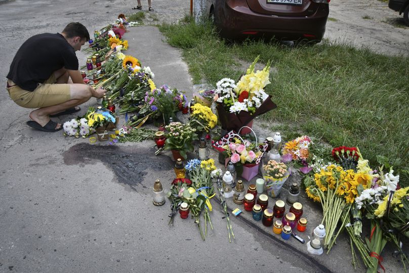 People lay flowers and light candles at a makeshift memorial in tribute to former Ukrainian nationalist lawmaker Iryna Farion at the place of her murder in Lviv, Ukraine