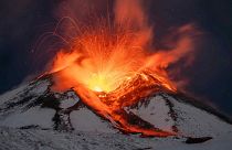 Lava erupts from snow-covered Mount Etna volcano, Sicily, Italy, early Saturday, Nov. 25, 2023. 