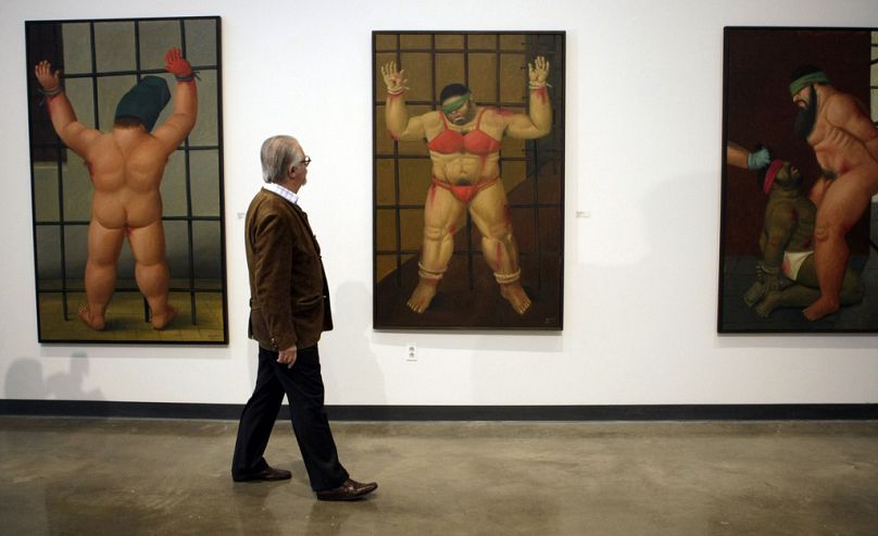 Colombian artist Fernando Botero looks over his work at a first complete U.S. showing of "Art of Confrontation," his paintings on Abu Ghraib prison at American University 