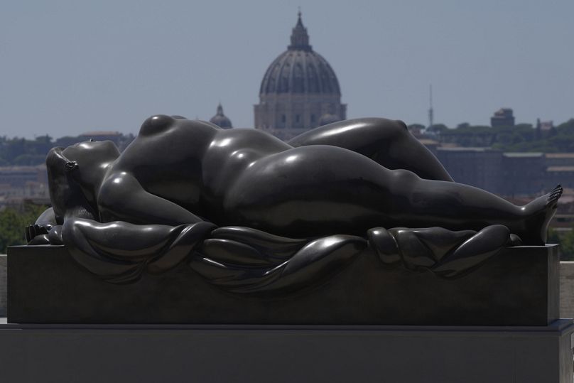 Botero's "Sleeping Venus" sculpture, installed in Rome's Pincio Terrace, appears to be in front of St. Peter's Basilica at The Vatican. 