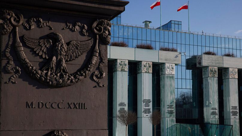 A woman walks in front of Poland's Supreme Court building in Warsaw, Poland, Thursday, Feb. 9, 2023. 