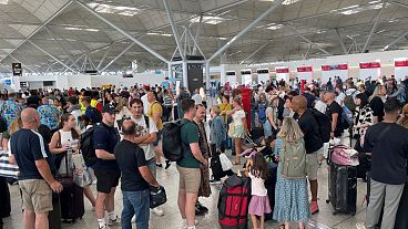 Passengers queueing at London Stansted Airport in Essex, amid reports of widespread IT outages affecting airlines, broadcasters and banks, 19 July, 2024. 