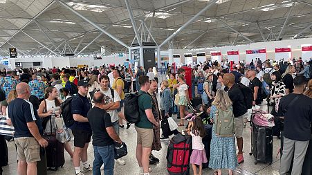 Passengers queueing at London Stansted Airport in Essex, amid reports of widespread IT outages affecting airlines, broadcasters and banks, 19 July, 2024. 