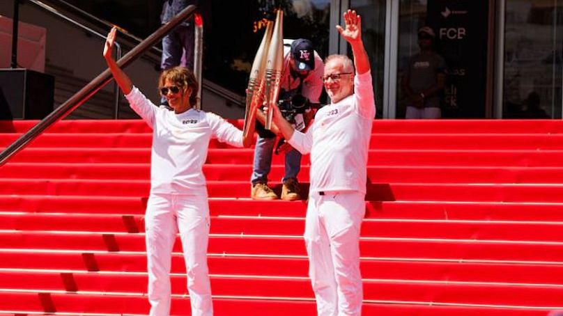 Actress Halle Berry & Thierry Fremaux with the Olympic Torch in front of the Palais des Festivals during the Cannes Lions International Festival Of Creativity - 18 June 2024