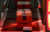 Packages riding on a belt are scanned to be loaded onto delivery trucks at the Amazon Fulfillment centre in New Jersey, 1 August 2017, FILE
