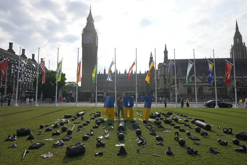 Former Ukraine wrestler Roksana Rakhra looks at a UK government arranged display at Parliament Square in London, Wednesday, July 24, 2024