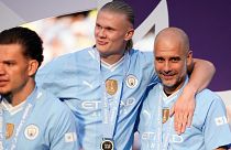 Manchester City's head coach Pep Guardiola, right, celebrates with Manchester City's Erling Haaland