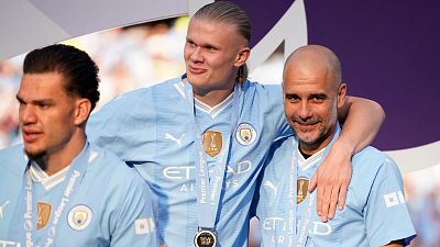 Manchester City's head coach Pep Guardiola, right, celebrates with Manchester City's Erling Haaland