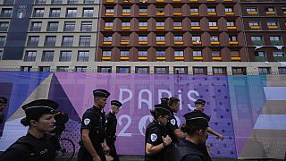 Police walk outside the perimeter of the Olympic Village, past housing for the Spanish, Italian and Moroccan teams, at the 2024 Summer Olympics, July 23, 2024, in Paris