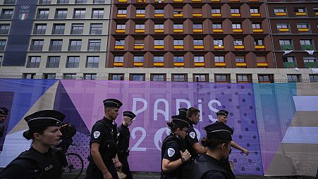Police walk outside the perimeter of the Olympic Village, past housing for the Spanish, Italian and Moroccan teams, at the 2024 Summer Olympics, July 23, 2024, in Paris