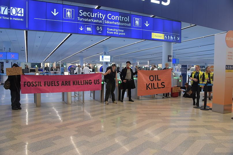 Activists block security control at Helsinki-Vantaa Airport. 