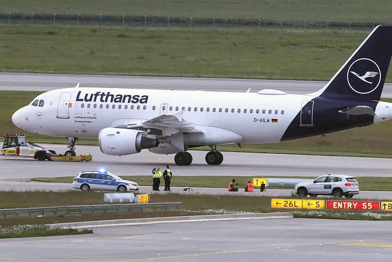 Climate activists lie on a access road for runways at the Munich airport, Germany, on 18 May, 2024.