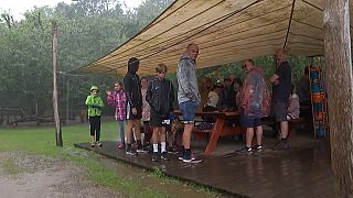 Turisti si riparano dalla pioggia