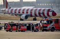 Emergency vehicles and police cars stand on a runway at the airport in Frankfurt, Germany, Thursday, July 25, 2024,
