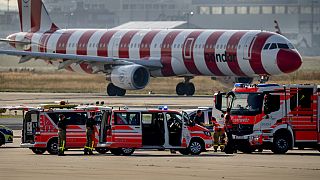 Emergency vehicles and police cars stand on a runway at the airport in Frankfurt, Germany, Thursday, July 25, 2024,