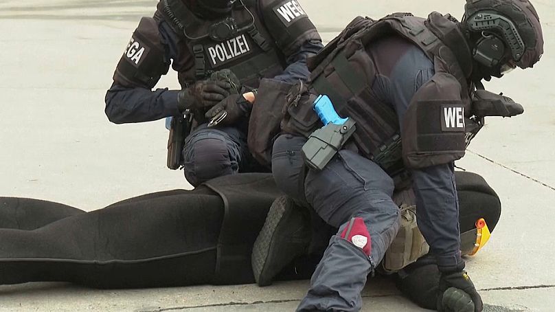 Police officers in Vienna subdue an 'assailant' after using a Taser, July 24, 2024