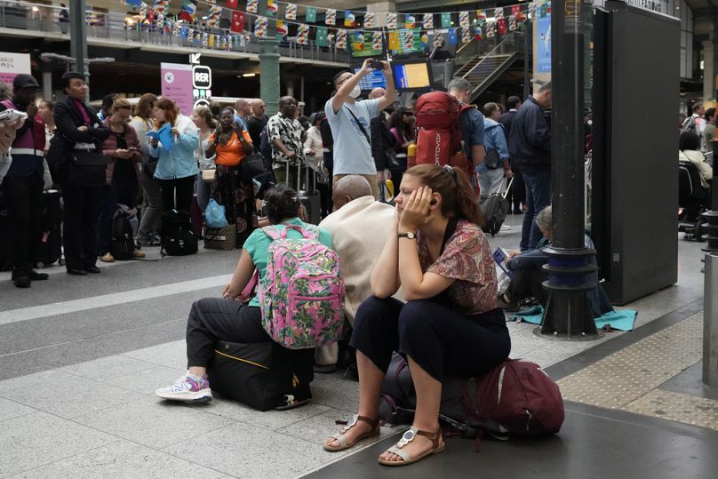 A traveller waits inside the Gare du Nord train station at the 2024 Summer Olympics, Friday, July 26, 2024, in Paris, France.