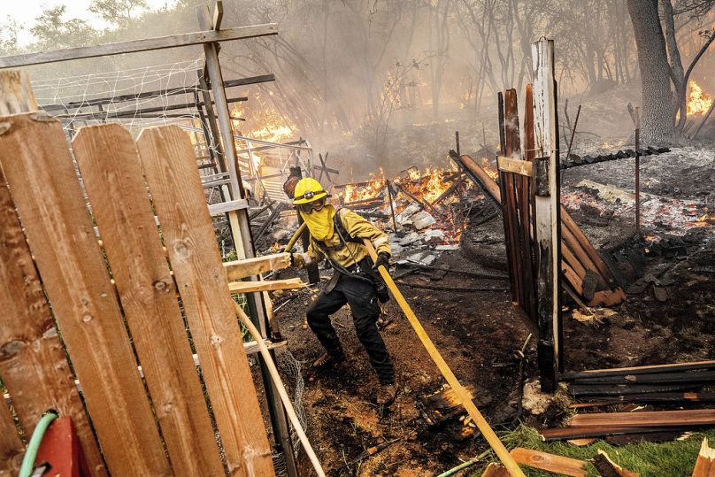 Firefighter Christian Moorhouse battles the Park Fire tears through the Cohasset community in Butte County.