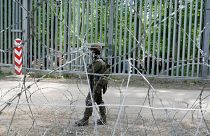 A Polish soldier patrols the border with Belarus