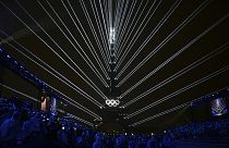 The Olympic rings are illuminated as lights emanate from the Eiffel Tower at the Trocadero during the opening ceremony for the 2024 Summer Olympics in Paris, France