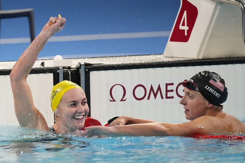 Ariarne Titmus, of Australia, left, celebrates after winning the women's 400-meter freestyle final as Katie Ledecky, of the United States, reacts at the 2024 Summer Olympics, 