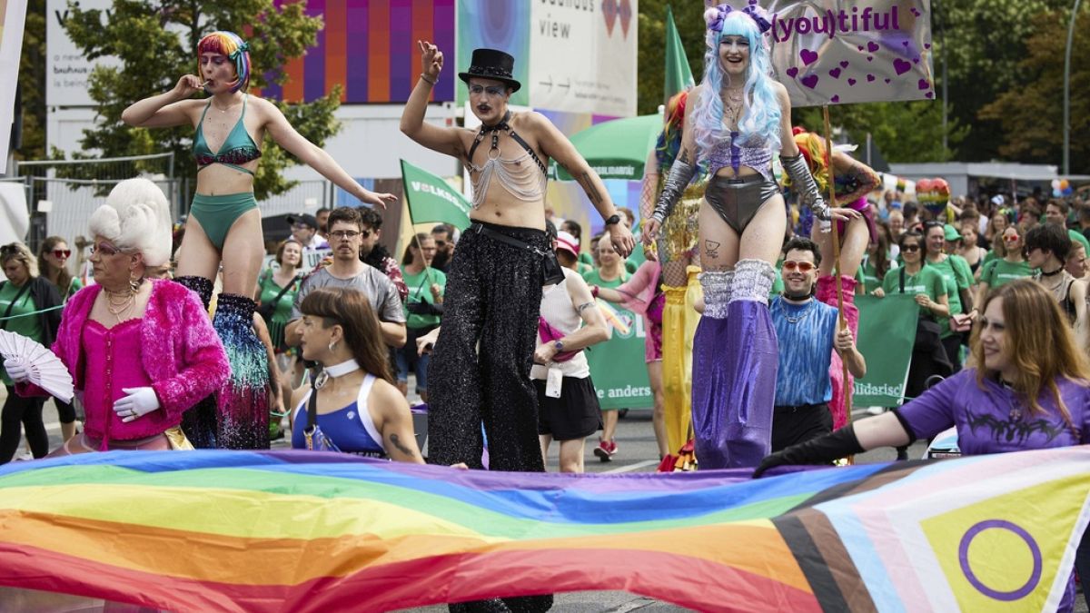 People on stilts take part in the 46th Berlin Pride for Christopher Street Day (CSD), in Berlin, Saturday July 27, 2024. (Joerg Carstensen/dpa via AP)