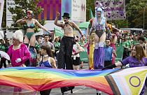 People on stilts take part in the 46th Berlin Pride for Christopher Street Day (CSD), in Berlin, Saturday July 27, 2024. (Joerg Carstensen/dpa via AP)