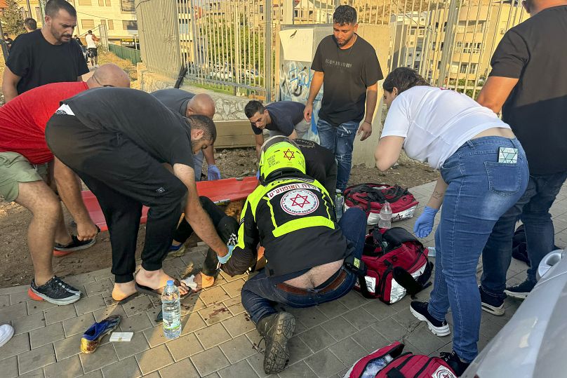 A paramedic attends to a young person moments after a rocket attack hit a football field in Majdal Shams, July 27, 2024