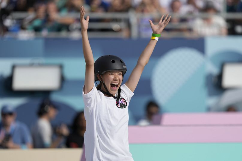 Coco Yoshizawa, of Japan, celebrates after winning the gold medal in the women's skateboard street final 