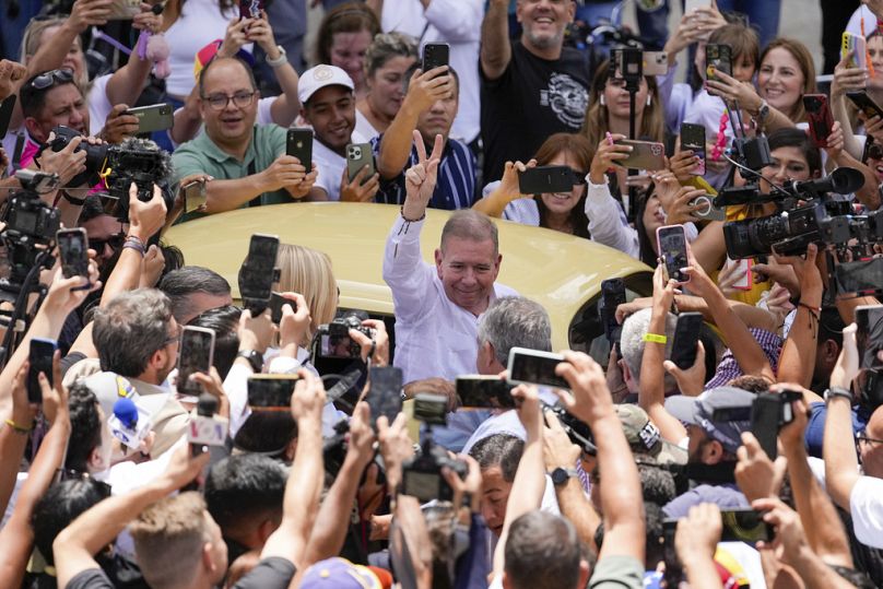 The opposition's presidential candidate Edmundo Gonzalez flashes a victory sign as he arrives to vote in the presidential election in Caracas