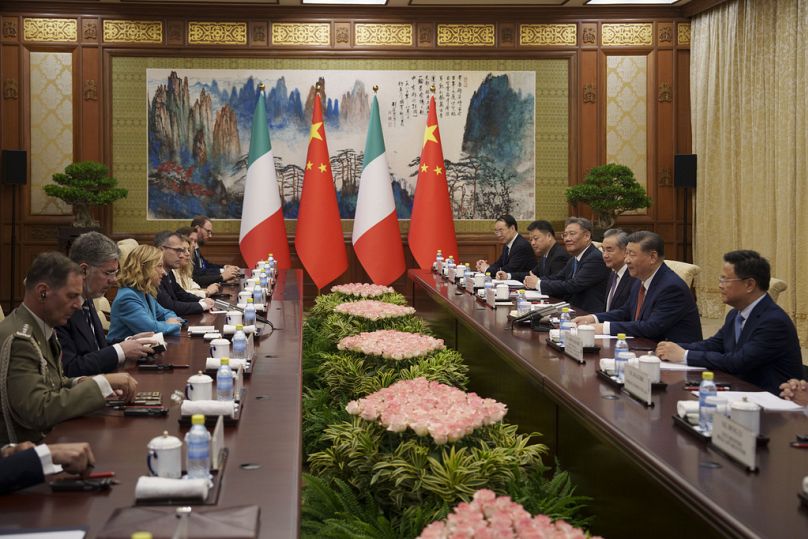 Chinese President Xi Jinping, second from right, and his delegation attend a meeting with Italian Premier Giorgia Meloni, left center, at the Diaoyutai State Guesthouse.