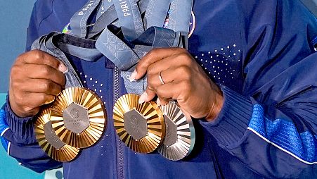 FILE: US gymnast Simone Biles holds up her medals during the women's artistic gymnastics finals at Bercy Arena at the 2024 Summer Olympics in Paris, 5 August 2024