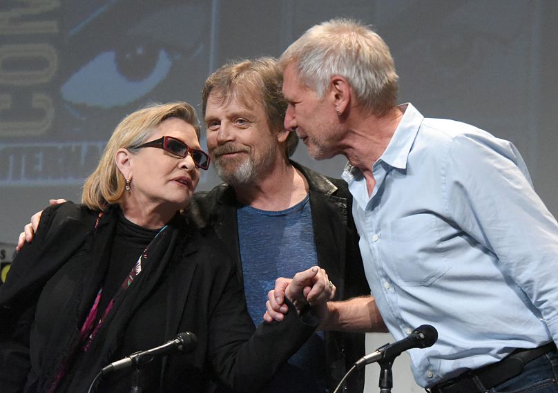 Carrie Fisher, from left, Mark Hamill, and Harrison Ford attend Lucasfilm's "Star Wars: The Force Awakens" on 18 December 2015.