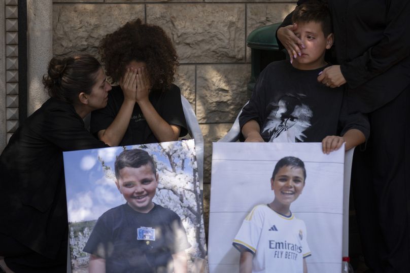 Des membres de la minorité druze pleurent lors des funérailles de Guevara Ibrahim, 11 ans, l'un des 12 enfants et adolescents tués.