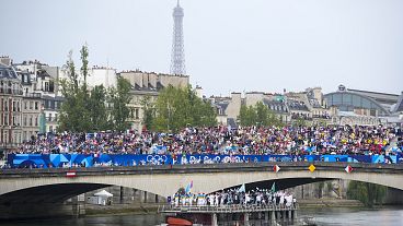 Athletes travel by boat down the Seine River in Paris, France, during the opening ceremony of the 2024 Summer Olympics on Friday 26 July 2024