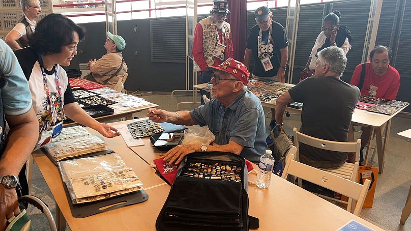 Robert Prat trading his pins at the official collectors venue, Parc des Nations, Paris