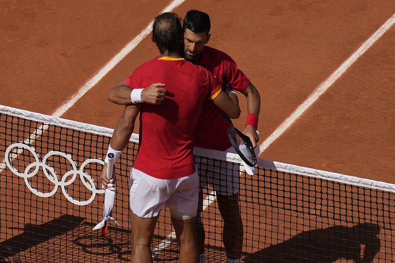 Djokovic and Nadal embrace after their men's singles second round match at the Roland Garros stadium at the 2024 Summer Olympics. 