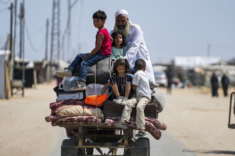 Palestinians displaced by the Israeli air and ground offensive on the Gaza Strip flee from parts of Khan Younis, following an evacuation order by the Israeli army to leave.