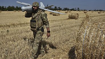 A soldier of Ukraine's National Guard 15th Brigade carries a reconnaissance drone in Zaporizhzhia region, Ukraine, Monday, July 29, 2024. (AP Photo/Andriy Andriyenko)