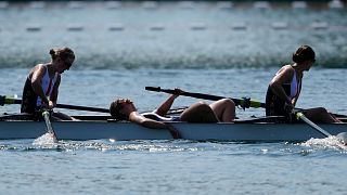 Some of the members of Team Denmark react at the end of the women's rowing eight heats.