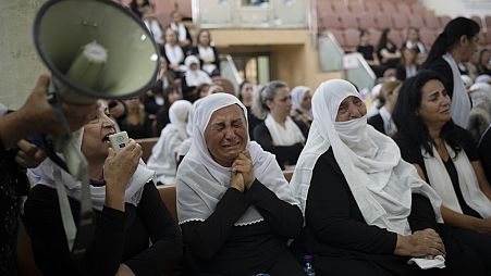 Members of the Druze minority attend a memorial ceremony for the children and teens, killed in a rocket strike in the village of Majdal Shams (AP Photo/Leo Correa)