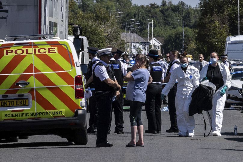 Police work at the scene in Southport, England, where a man has been detained and a knife has been seized