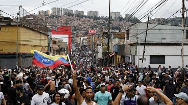 Protesters demonstrate against the official election results declaring President Nicolas Maduro won reelection in the Catia neighborhood of Caracas, Venezuela, Monday, July 29