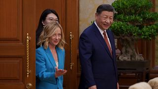 Chinese President Xi Jinping, right, walks with Italian Premier Giorgia Meloni, left, for a meeting at the Diaoyutai State Guesthouse in Beijing, China, Monday, July 29, 2024.