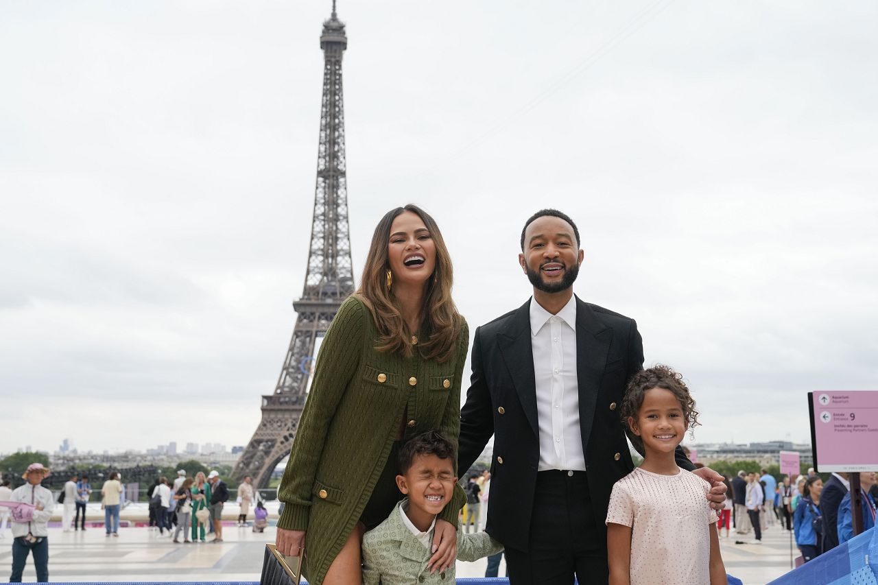 Chrissy Teigen and John Legend arrive with their children, Miles, foreground left and Luna in Paris, France, before the opening ceremony of the 2024 Summer Olympics