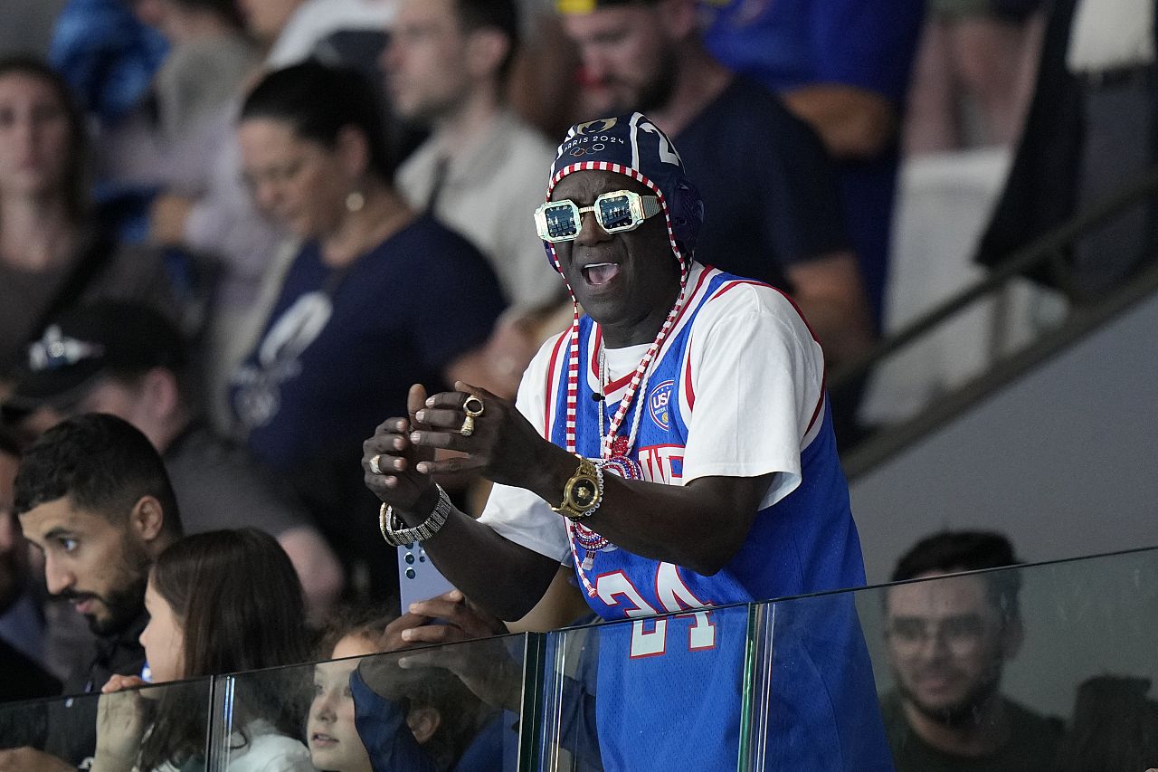 Legendary American rapper Flavor Flav celebrates after a women's Water Polo Group B preliminary match between USA and Greece at the 2024 Summer Olympics