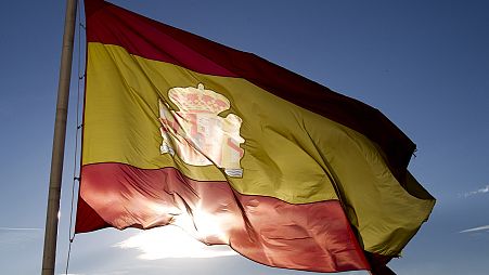 A Spanish flag flies above part of the Madrid skyline, 2 July 2012