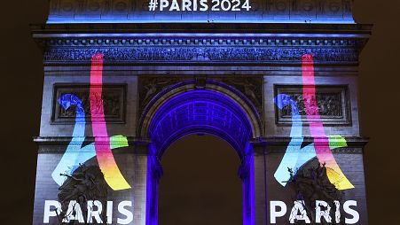 2024 Paris Olympics logo displayed on Arc de Triomphe